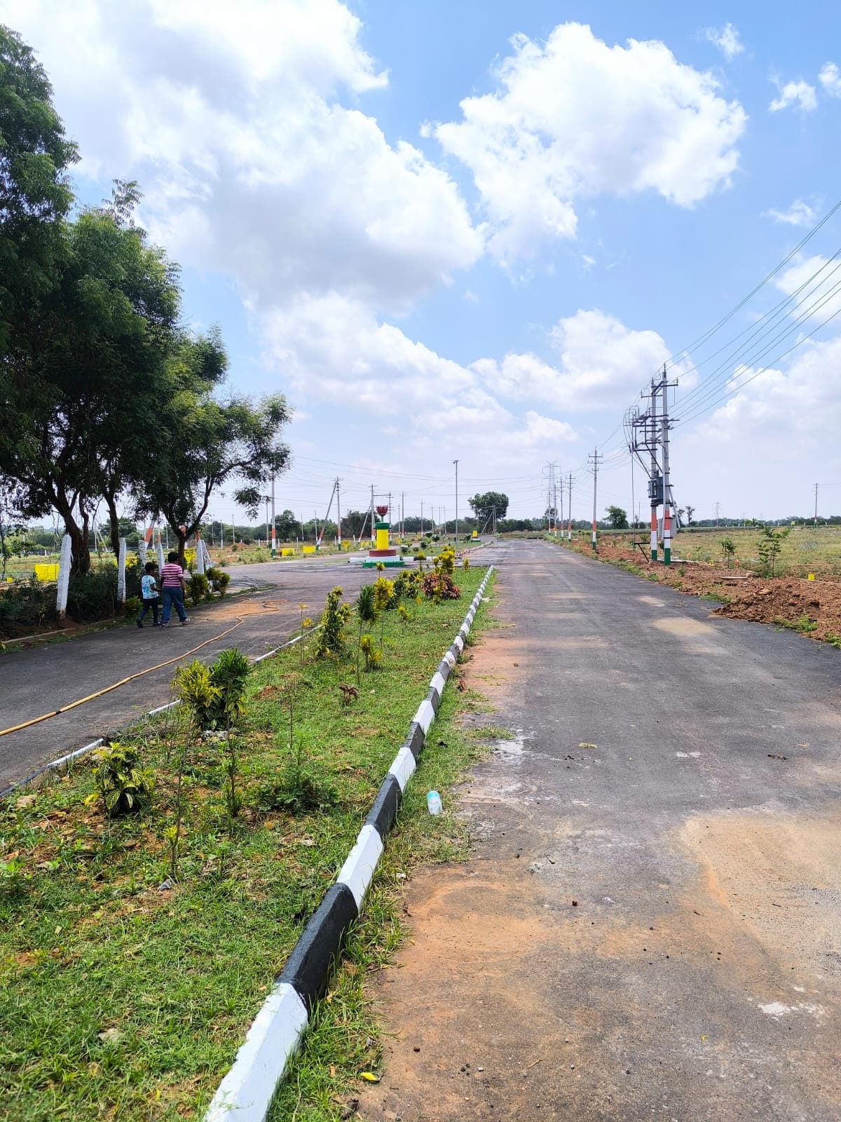 Planted median and asphalt roads in the layout under a blue sky